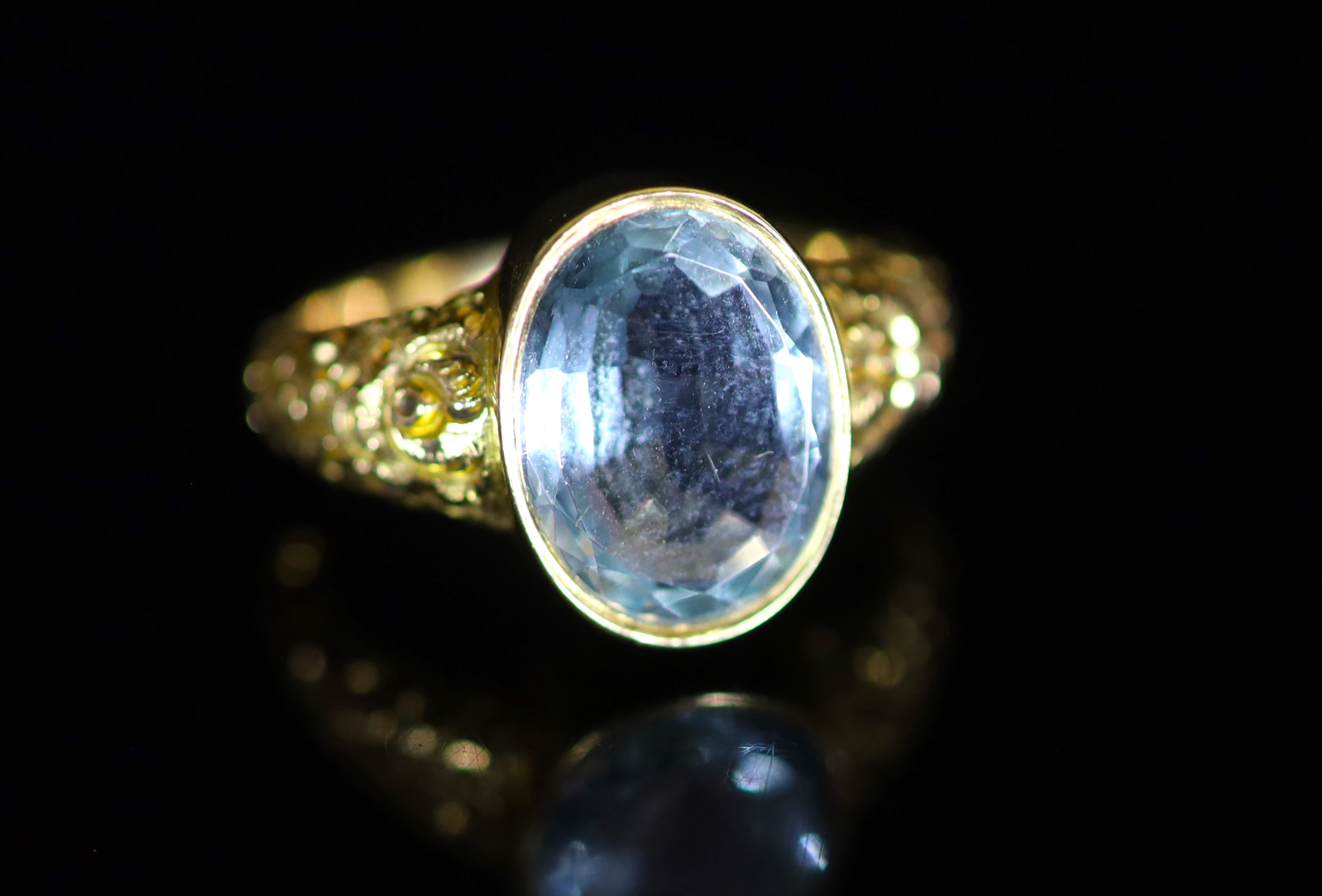 A Victorian style gold and single stone oval cut aquamarine dress ring